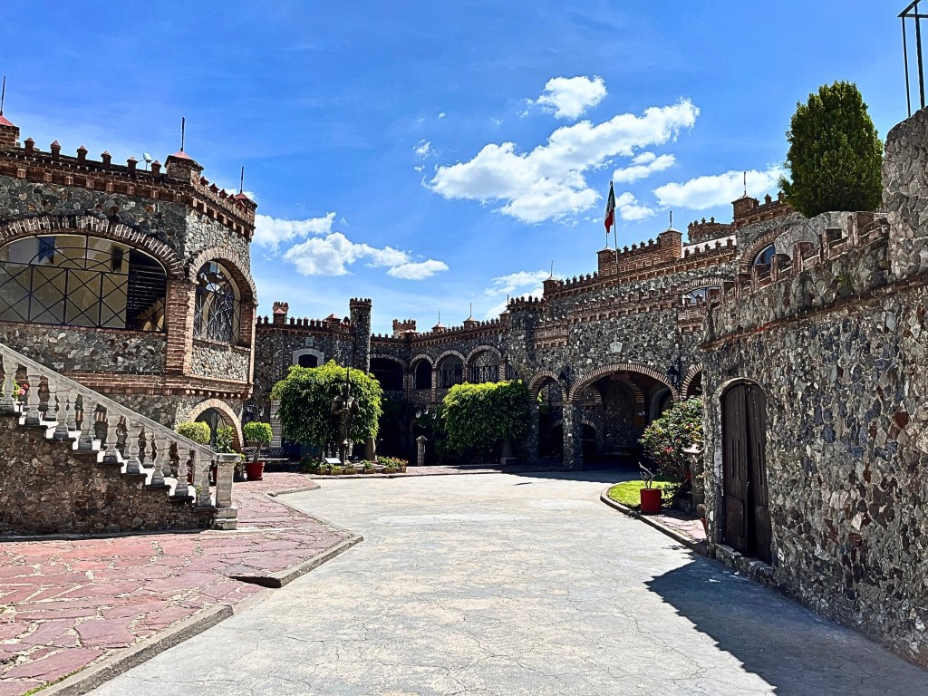Panoramic view of Castillo Santa Cecilia, a medieval stone building from Guanajuato, with blue sky on the background.
