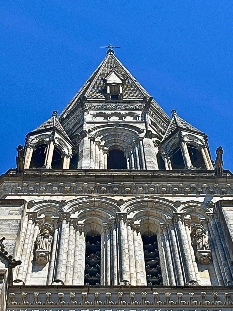 Neo-Gothic architectural details on the basilica’s upper façade, including columns and sculpted elements