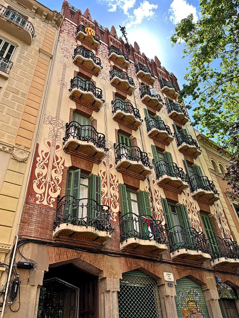 Close-up of Casa Rubinat's modernist wall and wrought iron balconies in Gràcia, Barcelona.