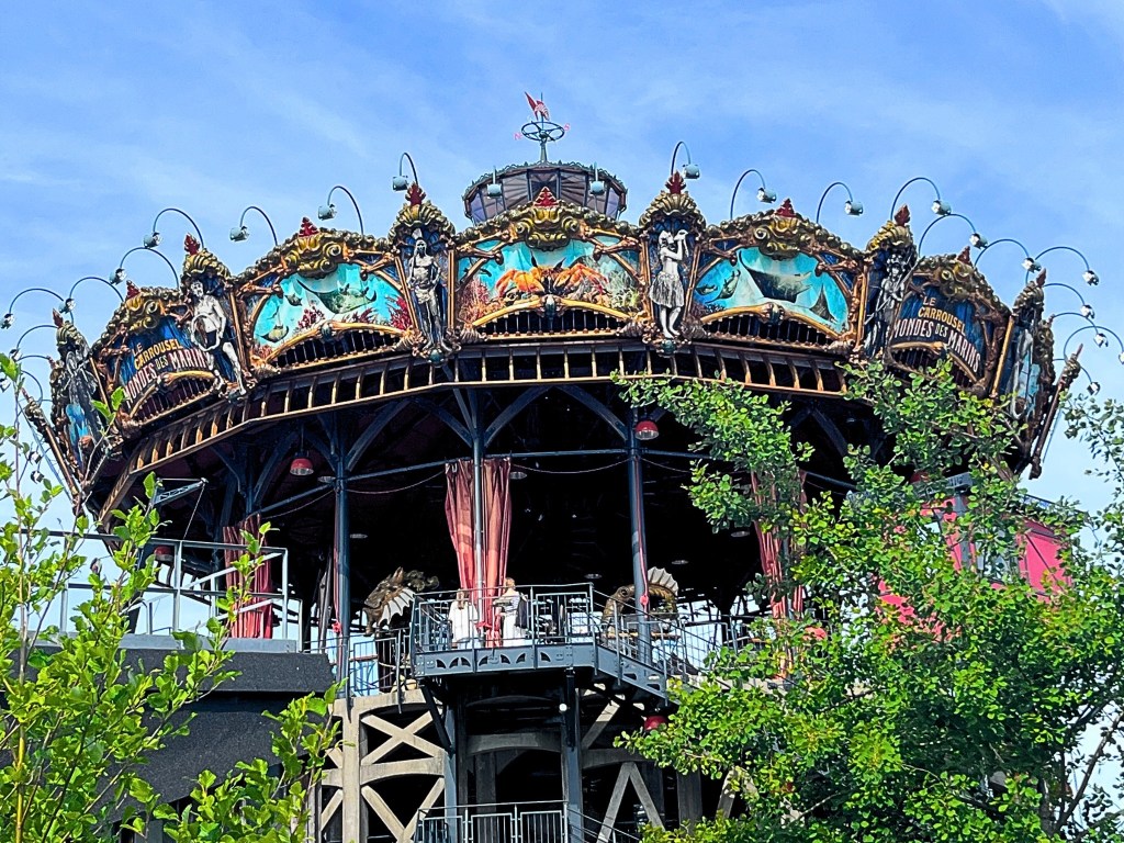 Three-level marine-themed carousel at Les Machines de l’Île Nantes, adorned with sculpted sea creatures, golden trim, and steampunk details inspired by Jules Verne.
