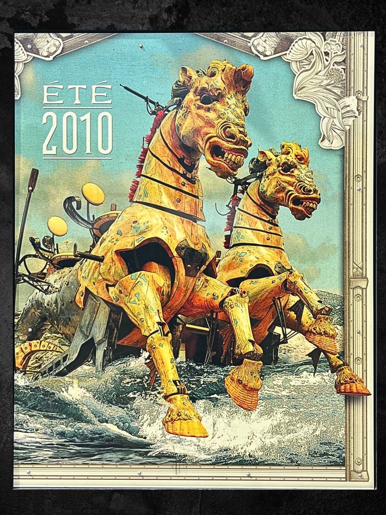 Poster of giant mechanical horses in motion at Les Machines de l’Île, with glowing festival lights, brass details, and a twilight fairground setting.