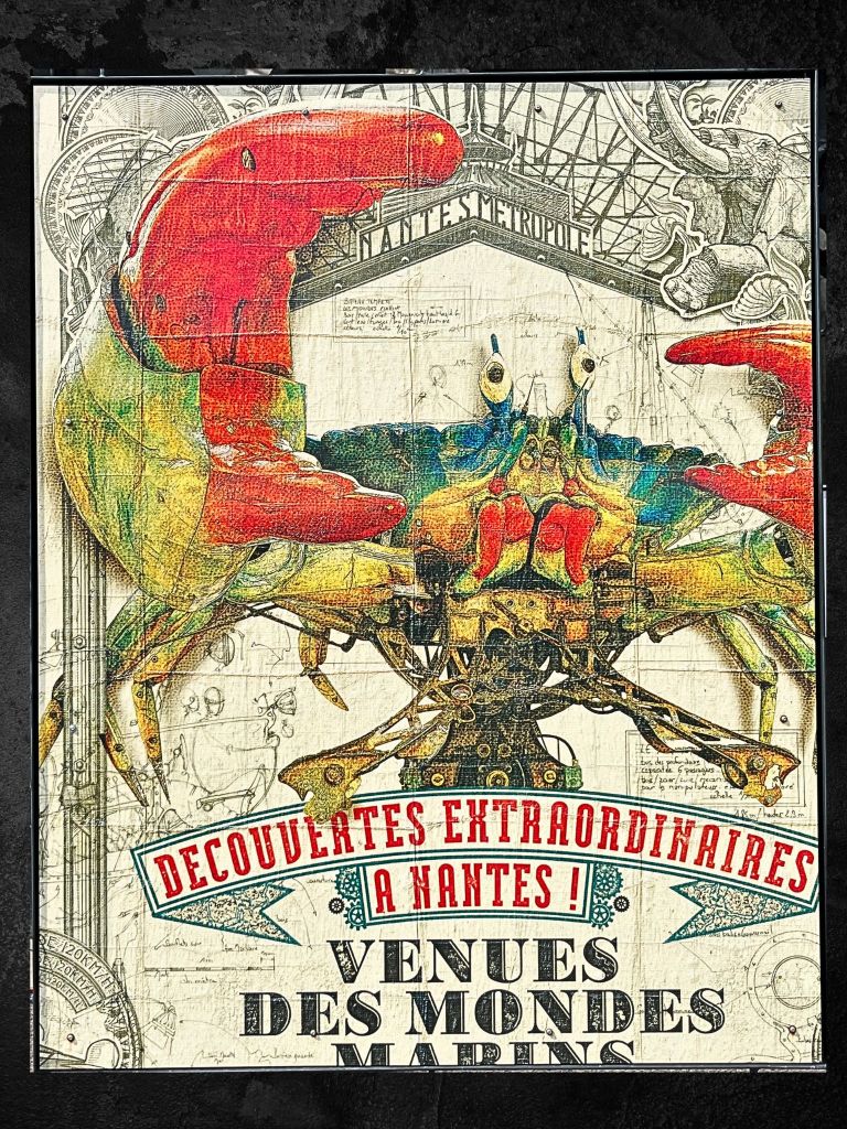 Poster of a vivid mechanical crab in ochres, yellows, and reds, set against a black-and-white pencil-drawn backdrop at Les Machines de l’Île in Nantes.