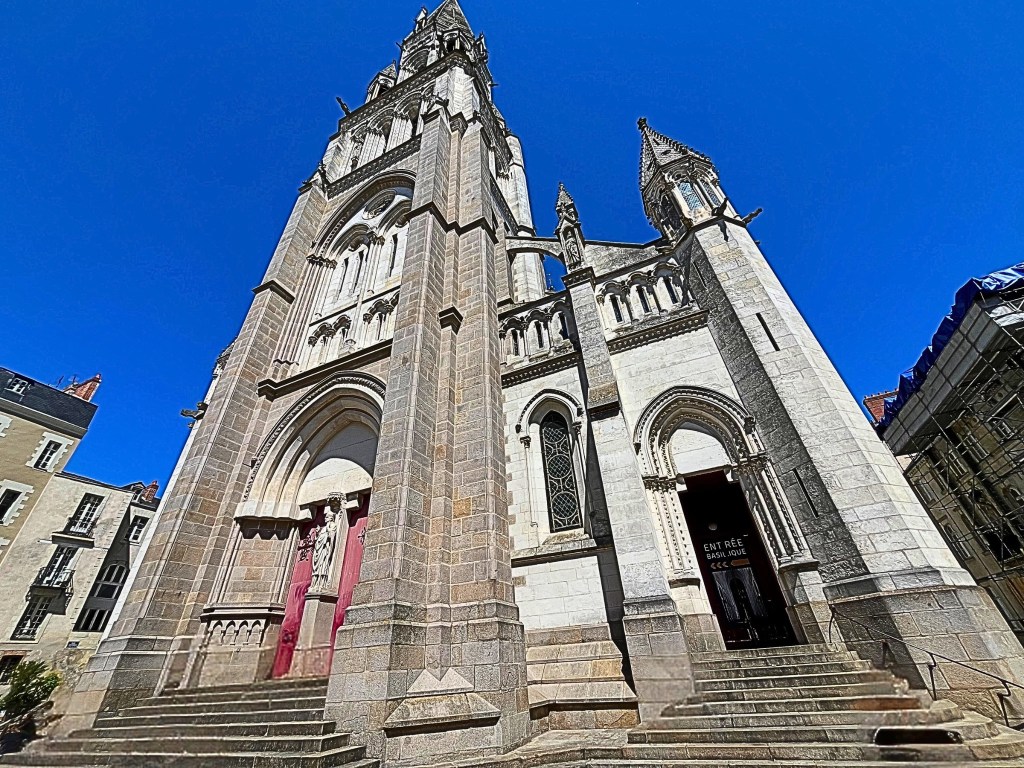 Neo-Gothic church in Nantes with pointed arches and ornate stone carvings.