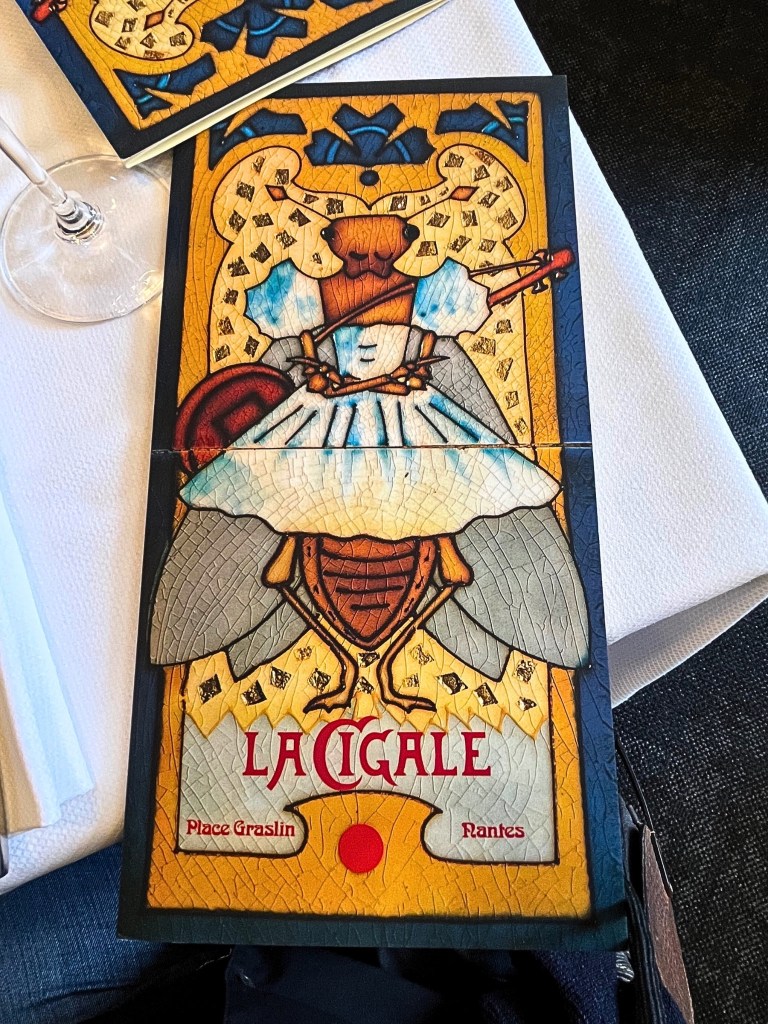 Art Nouveau-inspired menu cover from La Cigale in Nantes, featuring ornate typography and intricate illustrations that reflect the brasserie’s Belle Époque charm.