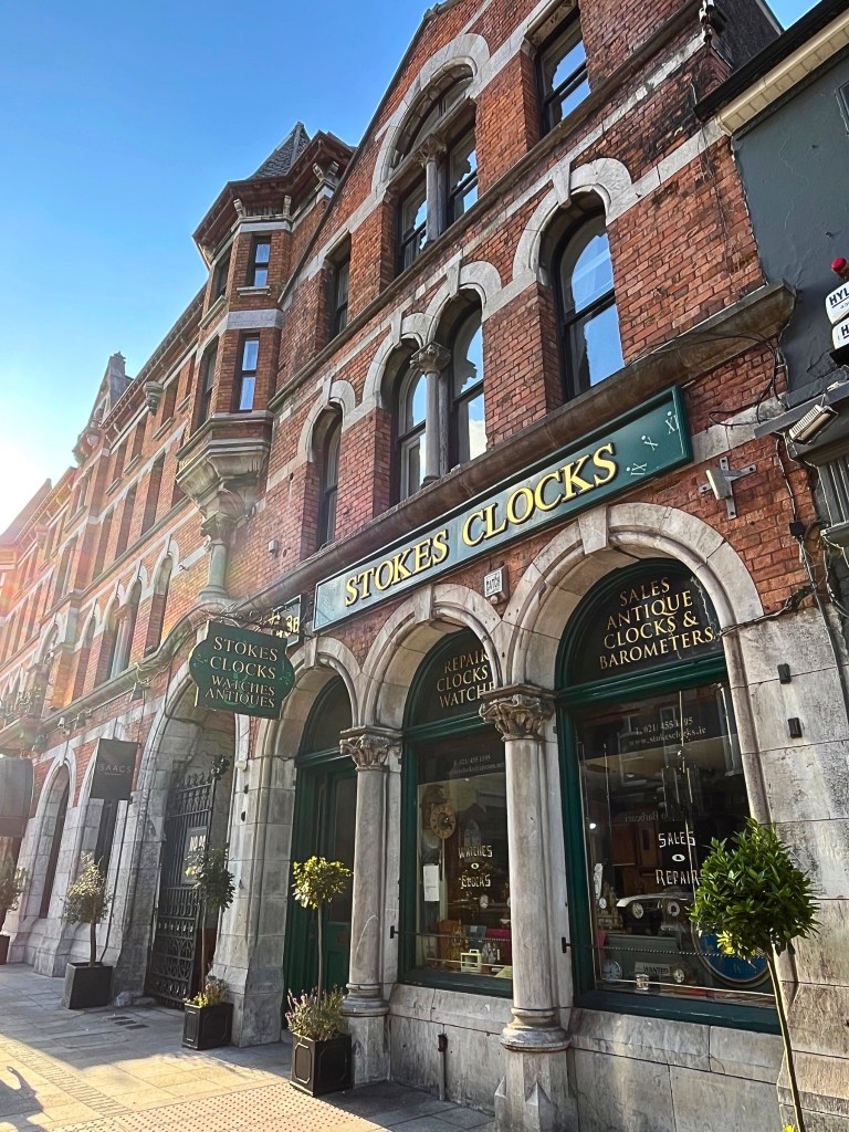 Facade of Stokes Clocks, a multi‑generation clock and watch specialist hidden just off MacCurtain Street. 