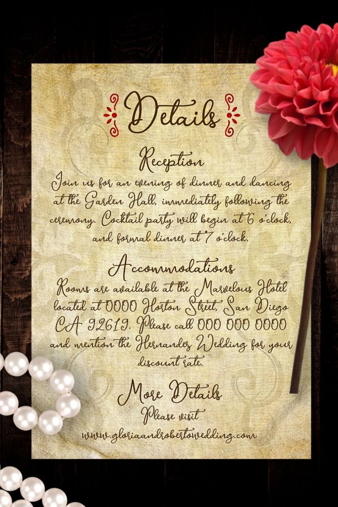 Vintage Baroque wedding details card from the Sacred Heart suite, featuring red flourishes, taupe calligraphy, and linen background styled with a red dahlia and pearl necklace.