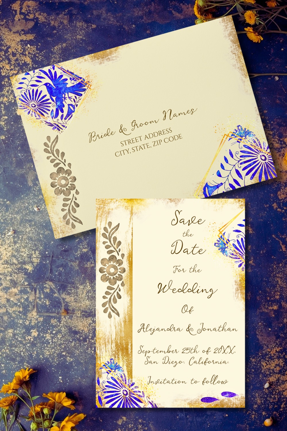 Blue and gold Talavera save the date card and envelope with floral folk art motifs and soft gold accents, styled on a textured indigo background with marigold flowers